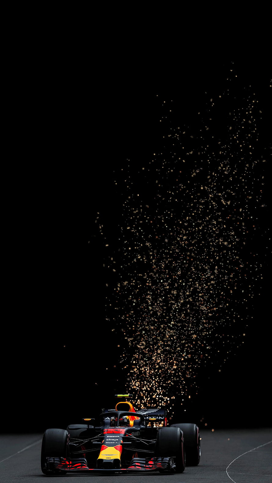 Red Bull Racing Formula 1 car with dramatic sparks on a dark track HD phone wallpaper
