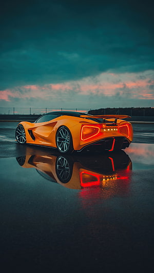 Orange Lotus Evija Hypercar Rear View on Wet Asphalt at Dusk HD phone wallpaper