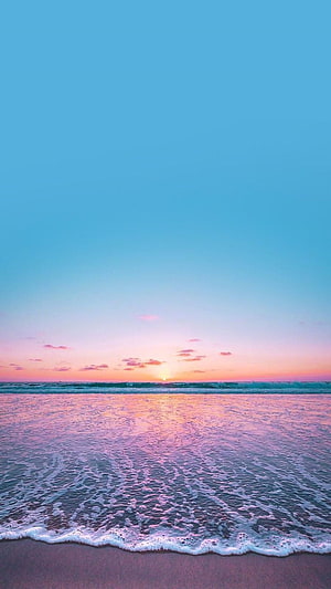 Serene Sunset Beach With Pink And Blue Sky Reflections On Ocean Waves HD phone wallpaper