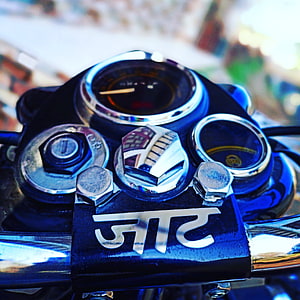 Close-up of a Jaat motorcycle handlebar with chrome gauges and polished metal details HD phone wallpaper