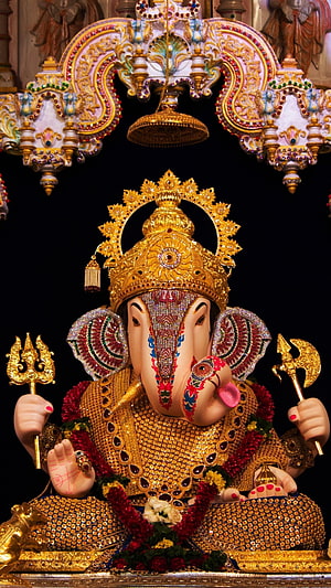 Ornate Golden Ganesha Idol with Jeweled Crown and Trishul HD phone wallpaper