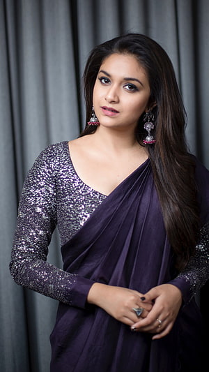Keerthi Suresh in a purple sequined saree with traditional jhumka earrings HD phone wallpaper
