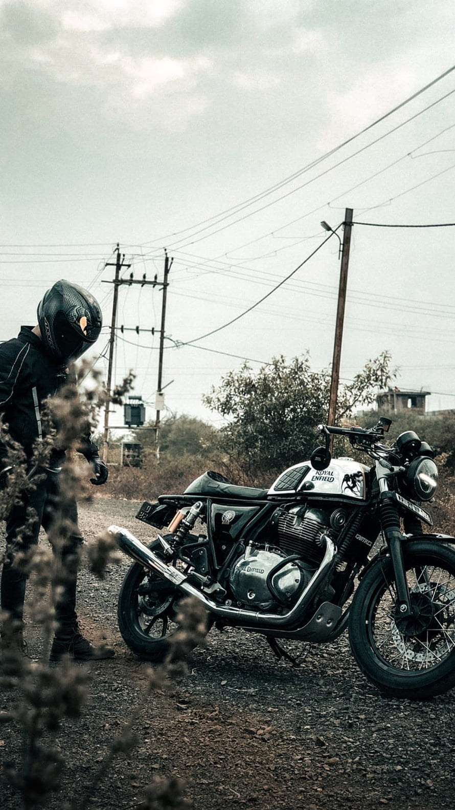 Royal Enfield Classic Motorcycle Parked on Gravel Road with Rider HD phone wallpaper