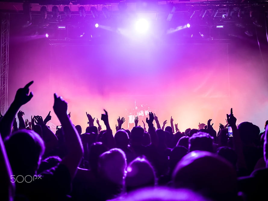 Vibrant Purple Concert Crowd Silhouettes Under Bright Stage Lighting HD wallpaper