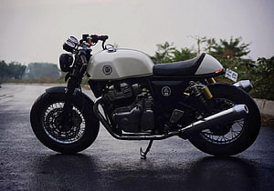 Custom Royal Enfield Cafe Racer Motorcycle with White Tank and Chrome Exhaust HD wallpaper