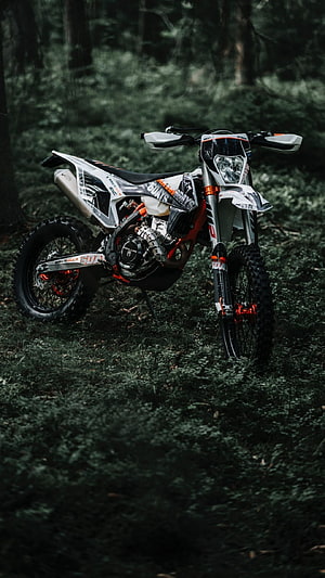 KTM SX-F Enduro Motorcycle Parked in a Dark Forest Setting HD phone wallpaper