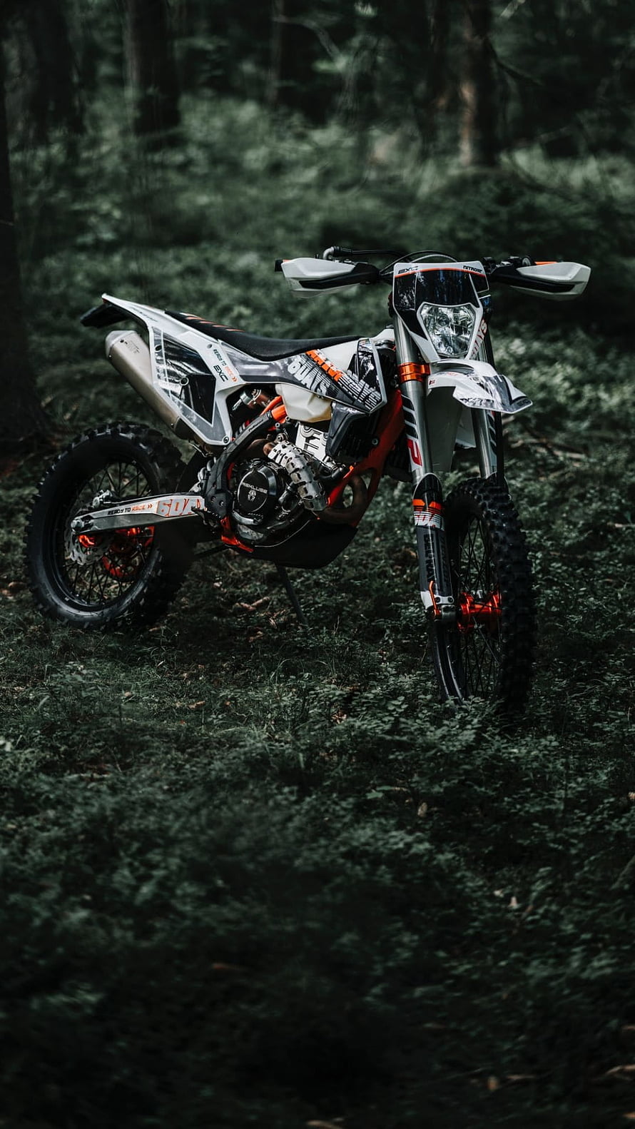 KTM SX-F Enduro Motorcycle Parked in a Dark Forest Setting HD phone wallpaper