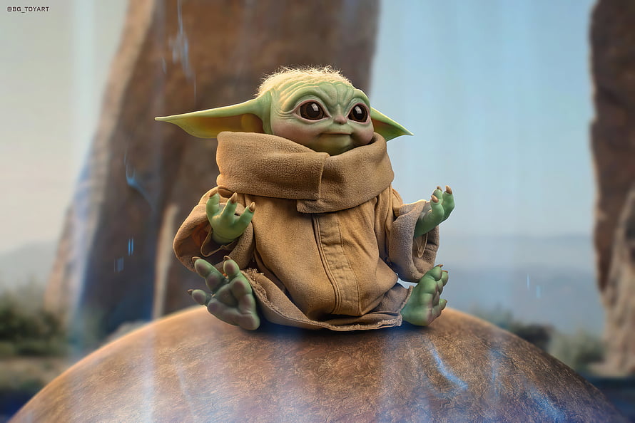Grogu from The Mandalorian Sitting on a Rock in a Desert Landscape HD wallpaper