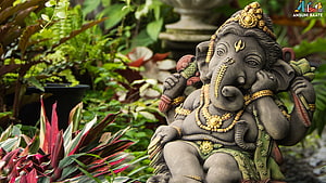 Ganesha Garden Statue Surrounded by Lush Tropical Foliage and Ornate Gold Jewelry HD wallpaper