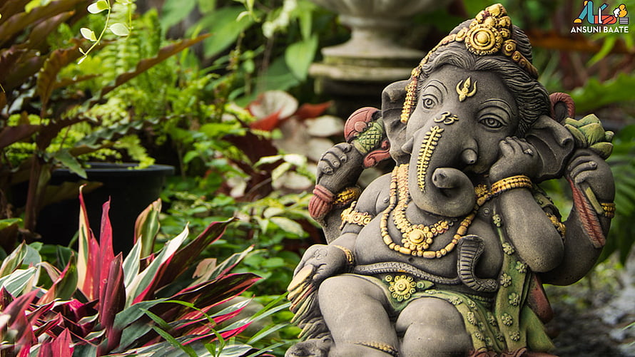 Ganesha Garden Statue Surrounded by Lush Tropical Foliage and Ornate Gold Jewelry HD wallpaper