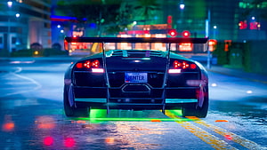 Rear View of a Black Supercar with Neon Underglow on a Wet City Street at Night HD wallpaper