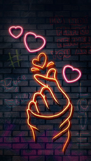 Neon Hand Gesture Making Heart Shape on Dark Brick Wall with Glowing Hearts HD phone wallpaper