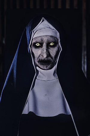Valak The Nun Horror Character Portrait with Glowing Yellow Eyes and Dark Habit HD phone wallpaper