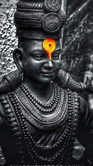 Black Stone Statue of Vitthal with Ornate Crown and Glowing Tilak HD phone wallpaper