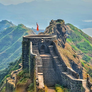 Rajgad Fort stone staircase and watchtower overlooking lush green mountain ridges in Maharashtra HD phone wallpaper