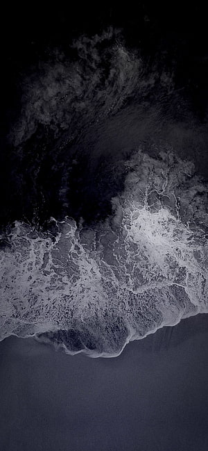 Aerial View of Dark Ocean Waves Crashing on Shore in Monochrome HD phone wallpaper