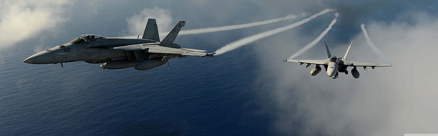 Two F-15 Eagle Fighter Jets Flying in Formation Over the Ocean with Vapor Trails HD wallpaper