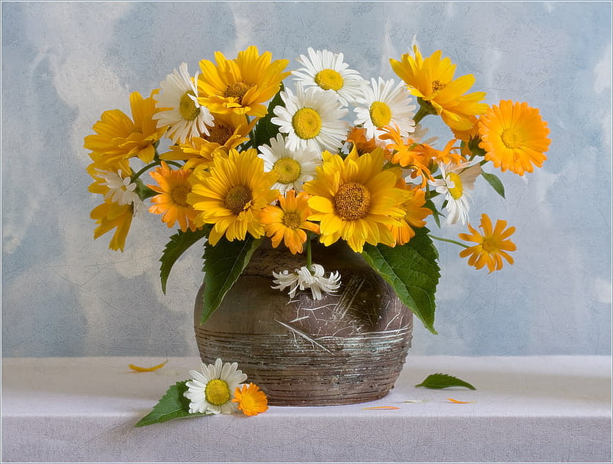 Vibrant bouquet of yellow and white daisies arranged in a rustic ceramic vase on a soft blue background HD wallpaper