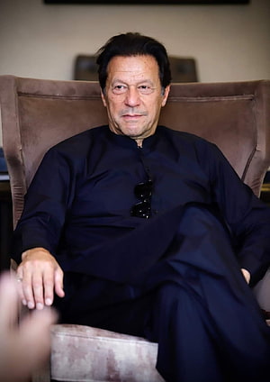 Imran Khan Sitting in a Brown Armchair Wearing a Dark Blue Traditional Outfit HD phone wallpaper