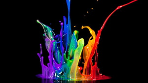 Vibrant Rainbow Paint Splash on Black Background HD wallpaper