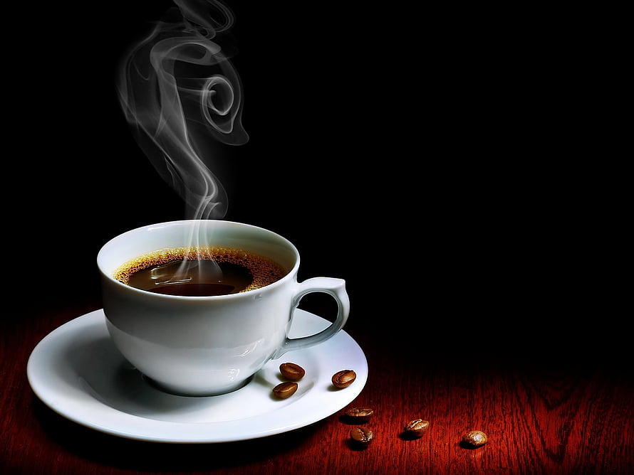 Steaming White Coffee Cup on Saucer with Scattered Beans on Dark Wood Table HD wallpaper