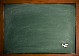 Empty Green Chalkboard with Wooden Frame and Chalk Pieces HD wallpaper