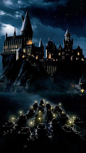 Hogwarts Castle at Night with Boats Crossing the Lake HD phone wallpaper
