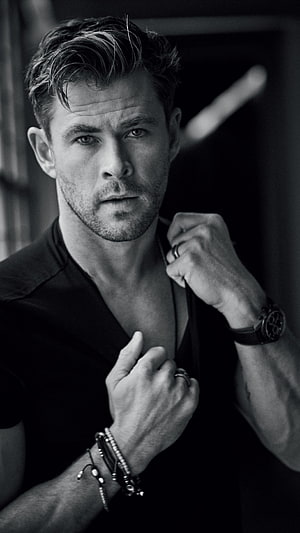 Chris Hemsworth Black and White Portrait with Intense Gaze and Studded Bracelets HD phone wallpaper