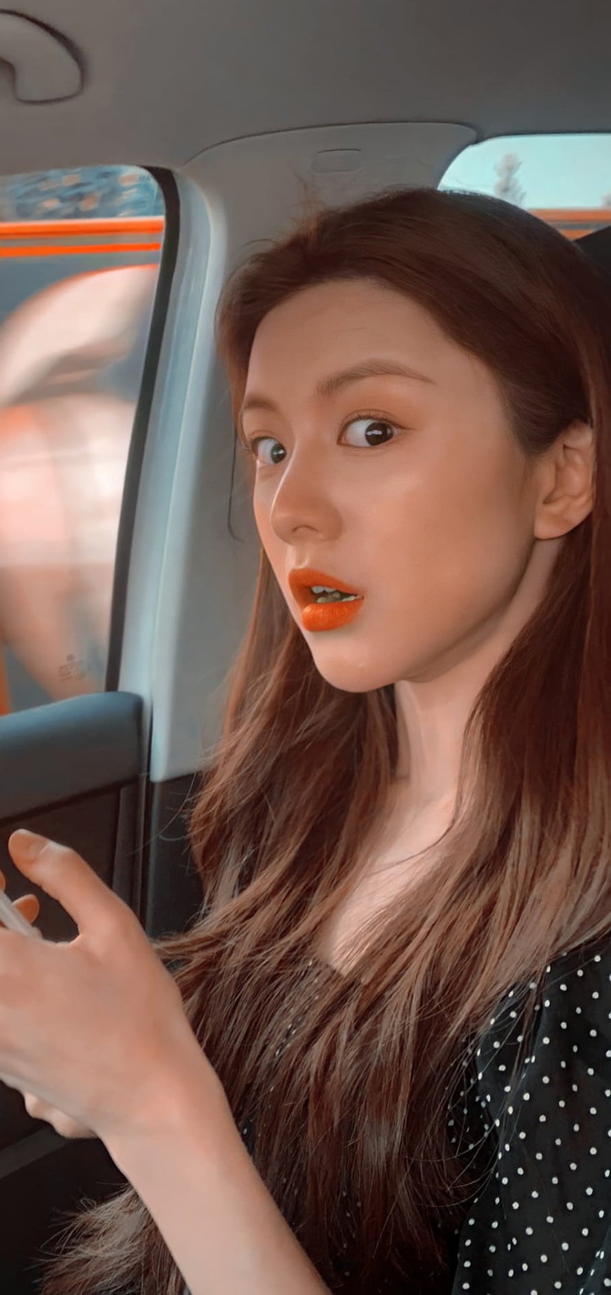 Go Yoon Jung in a car with long brown hair and bright orange lipstick HD phone wallpaper