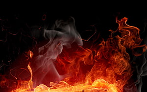 Dramatic Orange Flames and Billowing Smoke Against a Dark Background HD wallpaper