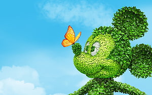 Mickey Mouse Topiary Sculpture with Orange Butterfly Against Blue Sky HD wallpaper