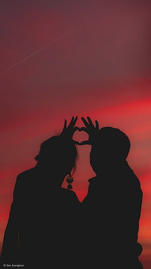Silhouette of Couple Making Heart Shape with Hands Against Red Sunset Sky HD phone wallpaper