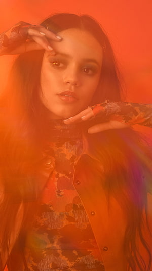 Jenna Ortega Portrait in Warm Orange Light with Dramatic Studio Lighting HD phone wallpaper