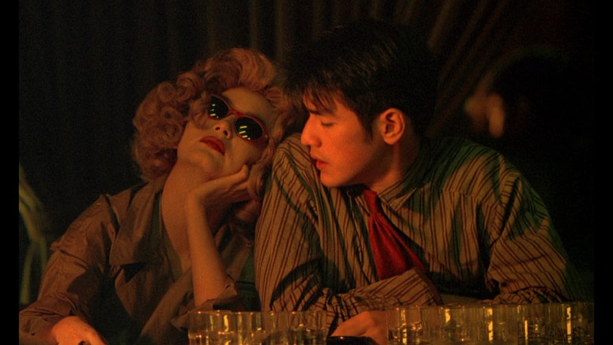 Chungking Express cinematic still of a couple in a dimly lit bar with warm amber lighting HD wallpaper