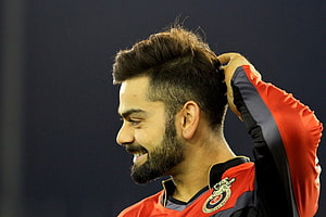 Virat Kohli in Royal Challengers Bengaluru Jersey Smiling During IPL Match HD wallpaper