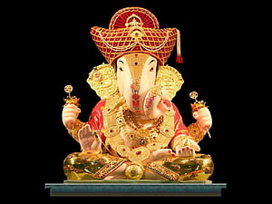 Ornate Golden Ganesha Murti with Red Crown and Jewels on Black Background HD wallpaper