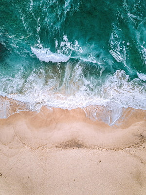 Aerial View of Turquoise Ocean Waves Crashing on Sandy Beach Shoreline HD phone wallpaper