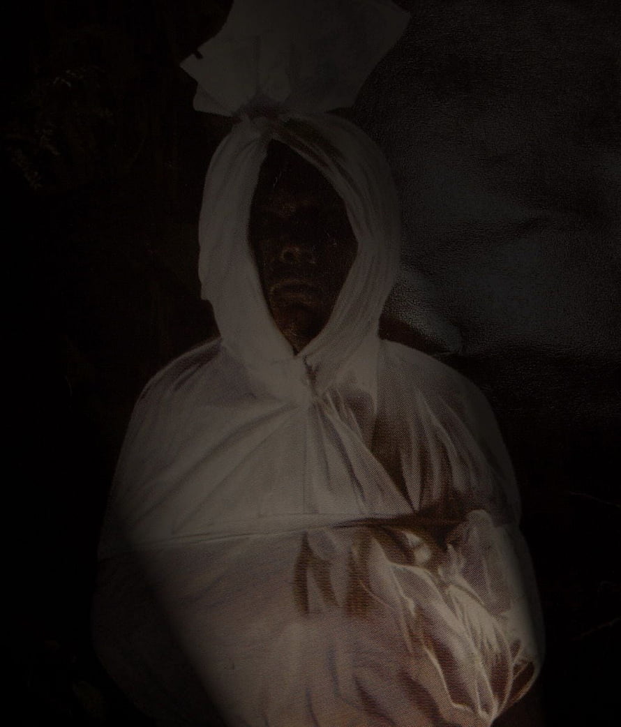 Pocong Ghost Wrapped in White Shroud with Dark Face in Shadowy Setting HD phone wallpaper