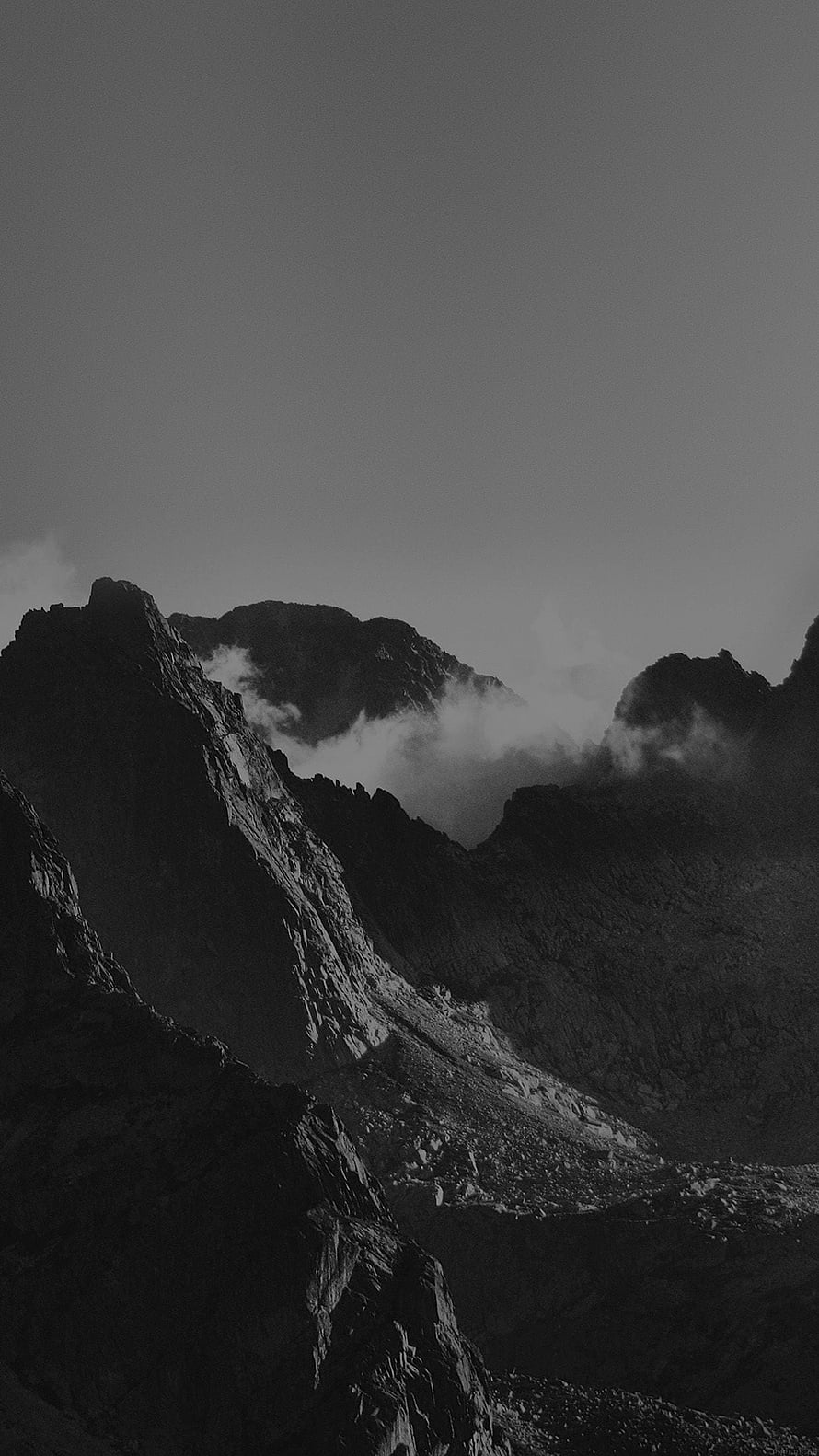 Monochromatic Mountain Peaks Shrouded in Low-Hanging Mist and Clouds HD phone wallpaper