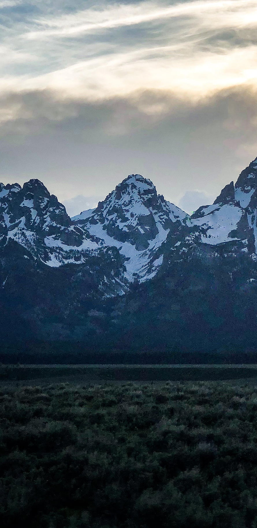 Snow-Capped Mountain Peaks Rising Above a Dark Valley at Dusk HD phone wallpaper