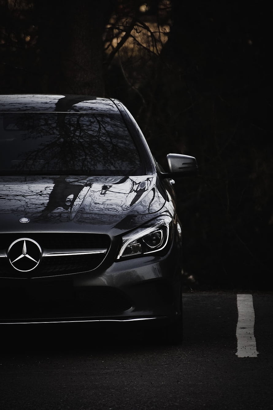 Black Mercedes-Benz C-Class Front Grille and Headlights in Dark Forest Setting HD phone wallpaper
