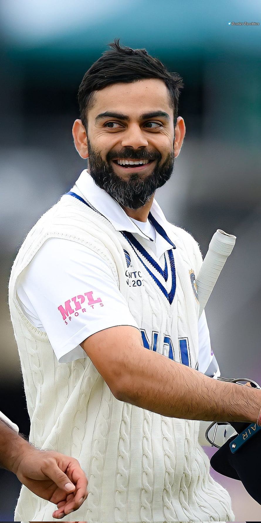 Virat Kohli smiling in white cricket test kit with bat and gloves on the field HD phone wallpaper