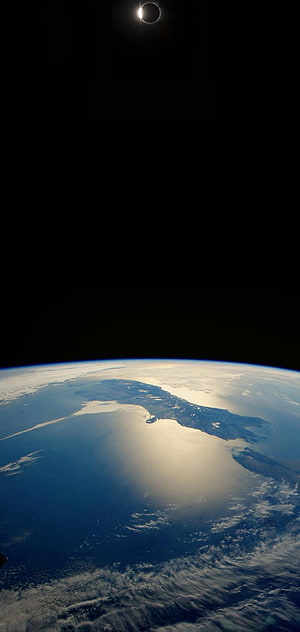 Solar Eclipse Over Earth From Space View With Ocean And Clouds HD phone wallpaper