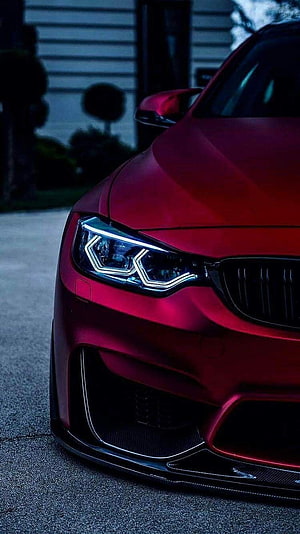 Close-Up of Matte Red BMW M3 Front Bumper and LED Headlights HD phone wallpaper