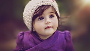 Adorable Toddler Girl in Purple Coat and Knit Beanie Looking Up HD wallpaper