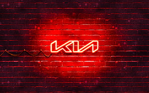 Kia Neon Logo Glowing on Dark Red Brick Wall with Dramatic Lighting HD wallpaper