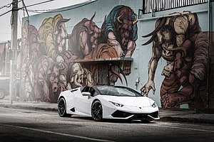 White Lamborghini Huracan Parked Before a Large Urban Street Art Mural HD wallpaper