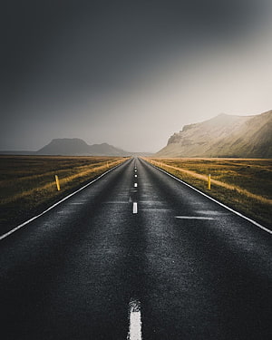 Moody Straight Highway Stretching Through Vast Open Landscape Under Dramatic Sky HD phone wallpaper