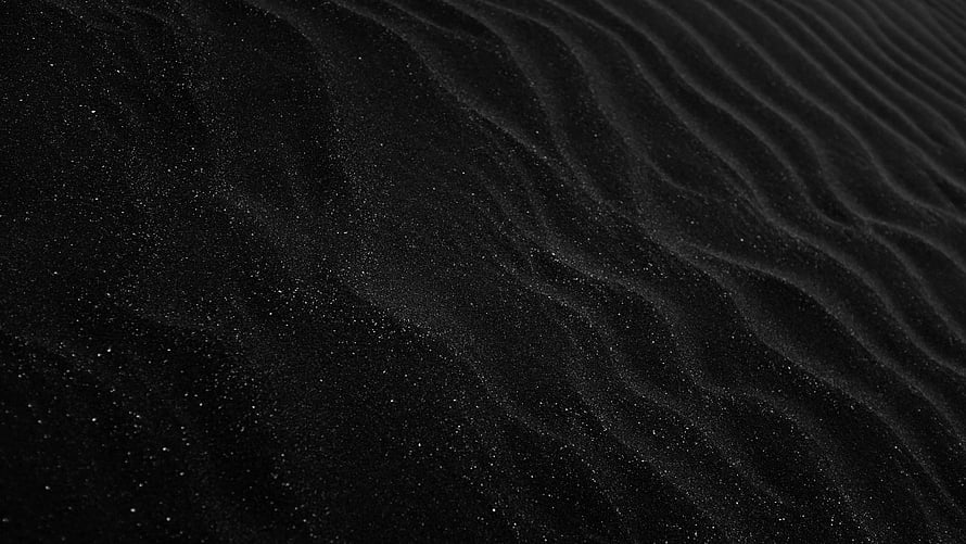 Dark Black Sand Texture with Fine Ripples and Grainy Surface Detail HD wallpaper