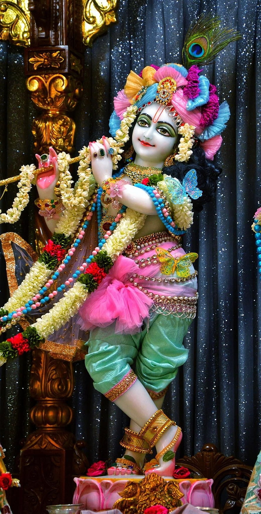 Colorful Lord Krishna Statue Playing Flute with Peacock Feather Crown HD phone wallpaper